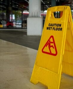 Caution wet floor sign in commercial area, relevant to wet floor slip case and warning signs liability.