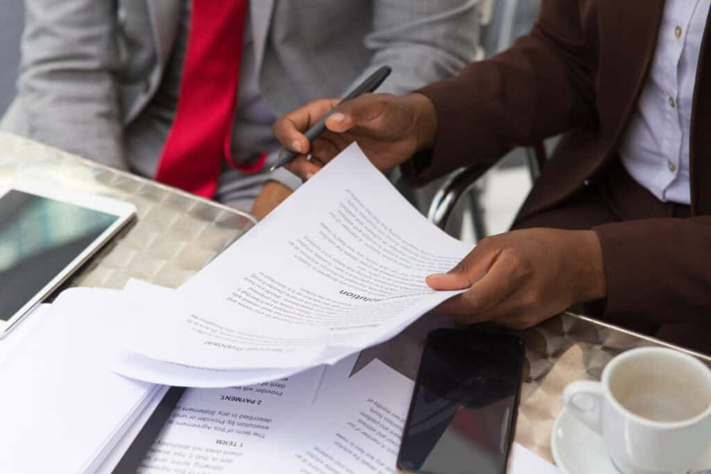 Close-up of hands reviewing legal documents during a lemon law claim preparation