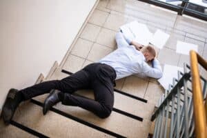 A worker falling down the stairs of a business place, representing Glendale slip and fall lawyer
