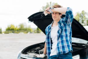 Mechanic diagnosing repeated engine issues that may qualify under California Lemon Law.