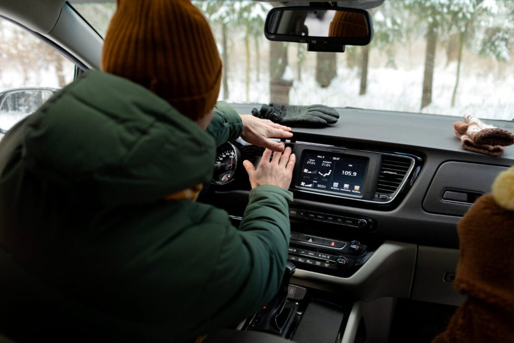 Driver adjusting faulty climate control system that may qualify as a lemon law defect.