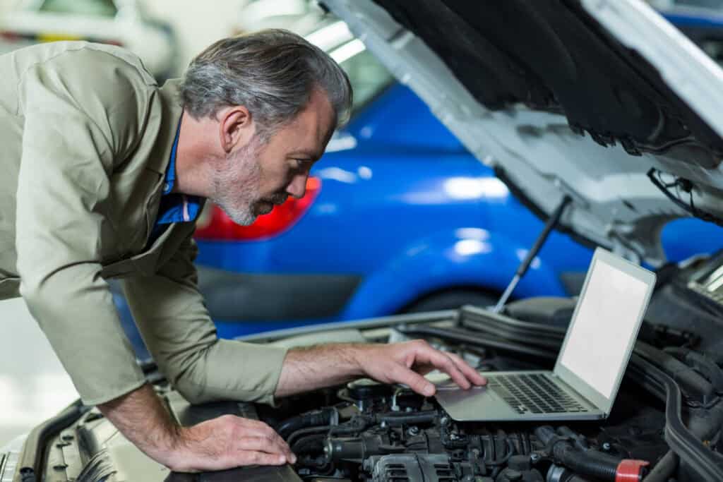 Mechanic diagnosing repeated engine issues that may qualify under California Lemon Law.
