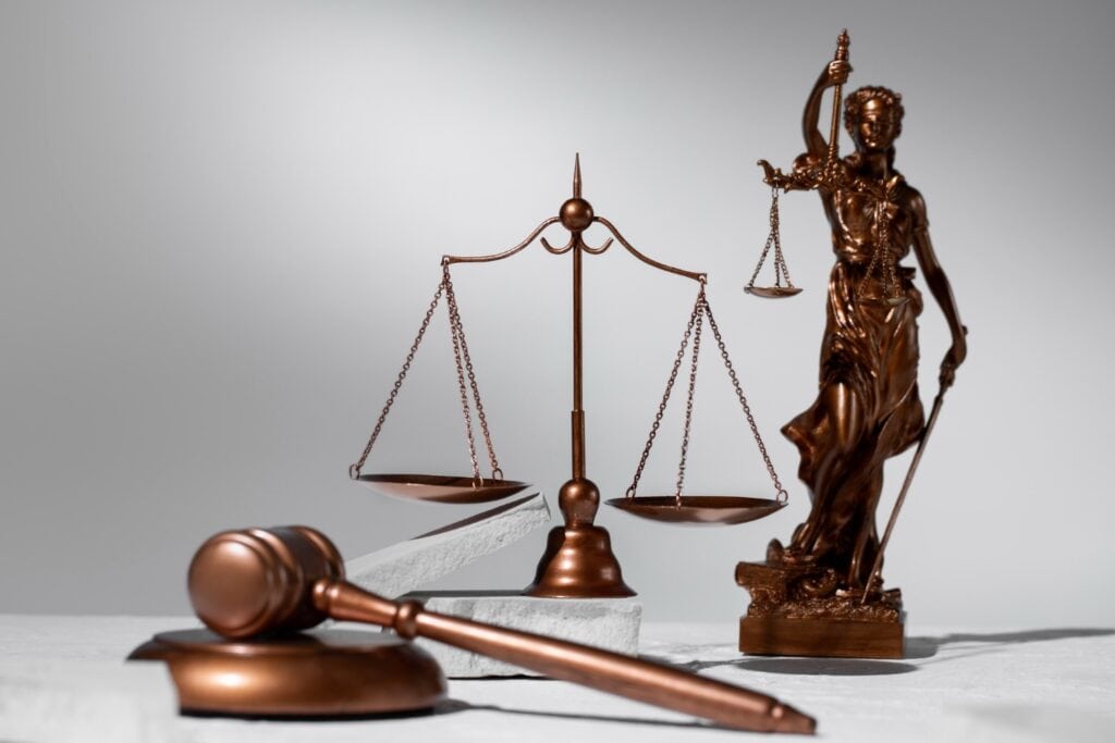 Bronze Lady Justice statue with scales and gavel symbolising fairness and emotional distress law in California.