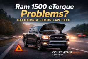 A black Ram 1500 eTorque truck with its hood open is parked on the roadside at dusk. A warning triangle is positioned in front of the truck. Text overlays promote California lemon law help from Court House Lawyers.